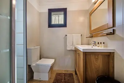 a bathroom with a toilet and a sink and a mirror at Isabel by Algarve Villa Holidays in Galé