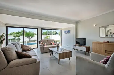 a living room with two couches and a tv at Isabel by Algarve Villa Holidays in Galé