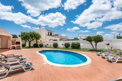 a villa with a swimming pool and lounge chairs at Isabel by Algarve Villa Holidays in Galé