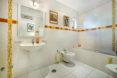 a bathroom with a sink and a toilet and a tub at Julieta by Algarve Villa Holidays in Galé