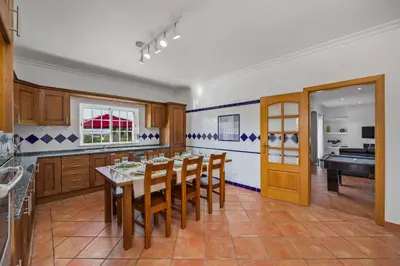 a dining room with a table and a piano at Laura by Algarve Villa Holidays in Albufeira
