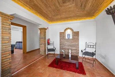 a living room with a fireplace and a wooden ceiling at Laura by Algarve Villa Holidays in Albufeira