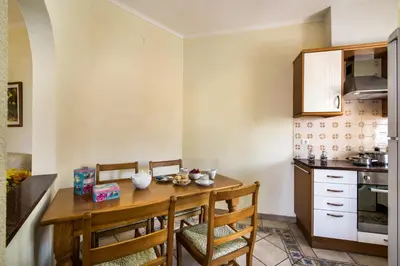 a small kitchen with a wooden table and chairs at Rebela by Algarve Villa Holidays in Galé