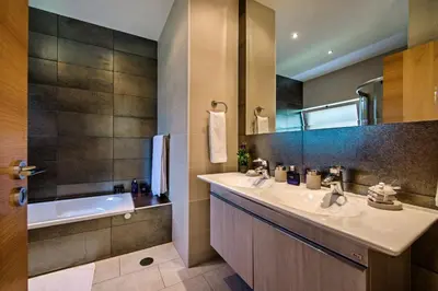 a bathroom with a sink and a bath tub and a tubermott at Vista Mar by Algarve Villa Holidays in Sesmarias