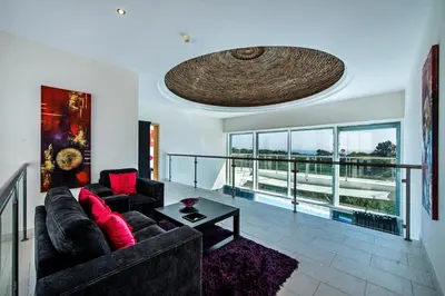 a living room with a couch and a table at Vista Mar by Algarve Villa Holidays in Sesmarias