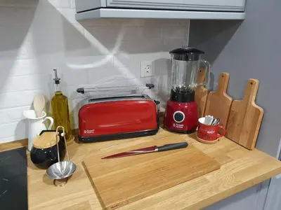 a kitchen counter with a red blender on a cutting board at Inn Faro - Casa Amarela - Guest House in Faro