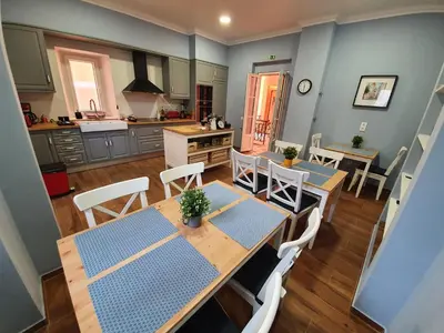 a kitchen and dining room with tables and chairs at Inn Faro - Casa Amarela - Guest House in Faro