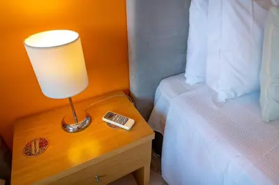 a lamp on a night stand next to a bed at Vila da Encosta - Private - Heated swimming pool - By bedzy in Albufeira