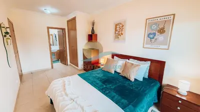 a bedroom with a large bed with blue and white sheets at Monte da Balaia Prime by Sunny Deluxe in Albufeira
