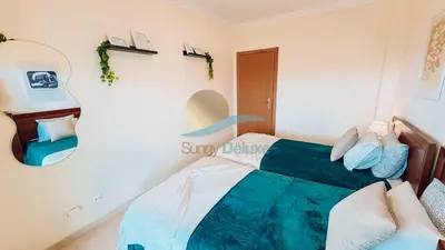 a bedroom with a bed and a mirror at Monte da Balaia Prime by Sunny Deluxe in Albufeira