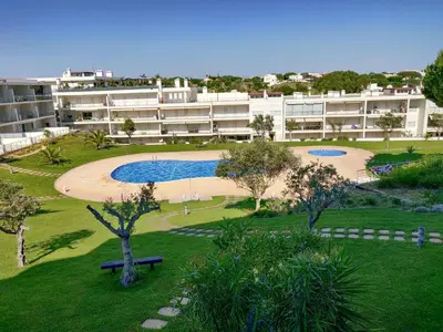 an apartment building with a pool in a park at Monte da Balaia Prime by Sunny Deluxe in Albufeira
