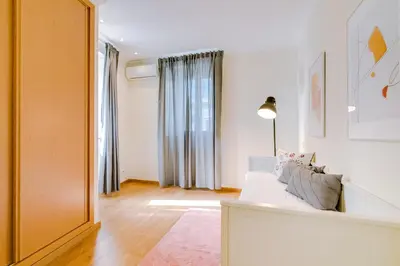 a living room with a white couch and a window at Casa Azul Traditional House - Faro in Faro