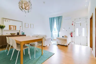a living room with a dining room table and chairs at Casa Azul Traditional House - Faro in Faro