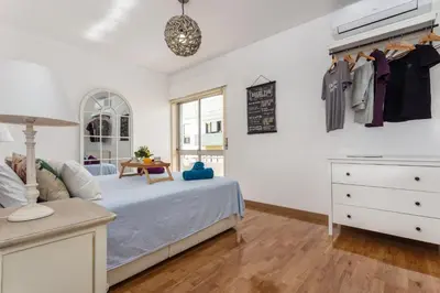 a bedroom with a bed and a dresser at Magic Theatre Faro Center in Faro