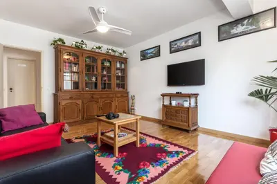 a living room with a red couch and a tv at Magic Theatre Faro Center in Faro