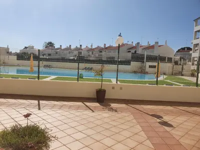 a fence with a swimming pool in the background at GA-DAL Stay Inn in Albufeira