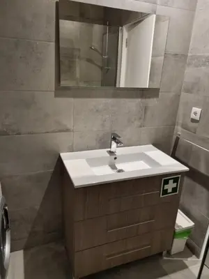 a bathroom with a sink and a mirror at GA-DAL Stay Inn in Albufeira
