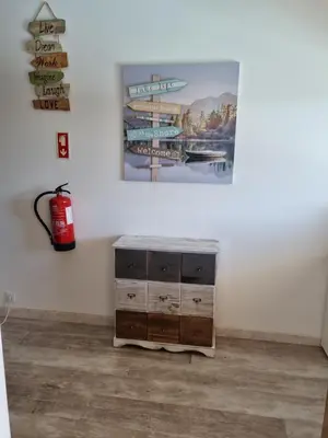 a room with a fire hydrant and a painting on the wall at GA-DAL Stay Inn in Albufeira