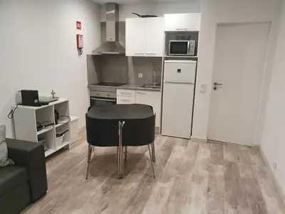 a small kitchen with a table and a couch at GA-DAL Stay Inn in Albufeira