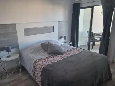 a bedroom with a large bed and a window at GA-DAL Stay Inn in Albufeira