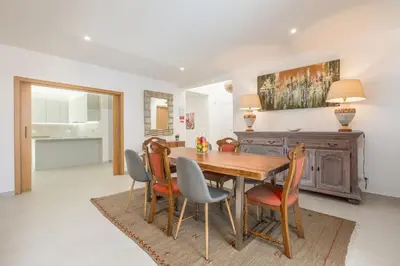 a dining room with a wooden table and chairs at Villa Alfazema - heatable pool in Albufeira
