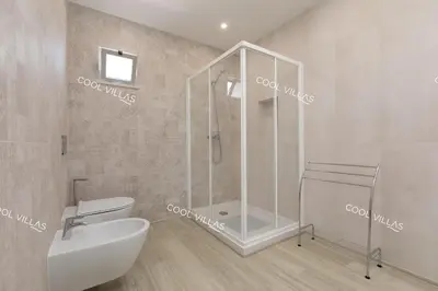 a bathroom with a shower and a toilet and a sink at Villa Alfazema - heatable pool in Albufeira