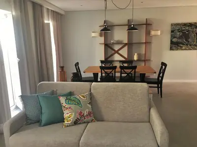 a living room with a couch and a table at Cardeal Suites & Apartments in Faro