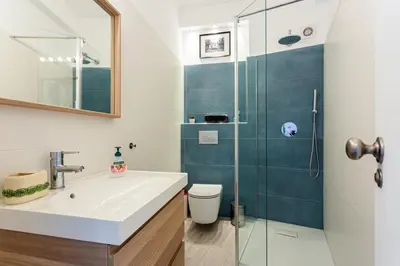 a bathroom with a sink and a shower at Dreamers Duplex with Seaview in Faro