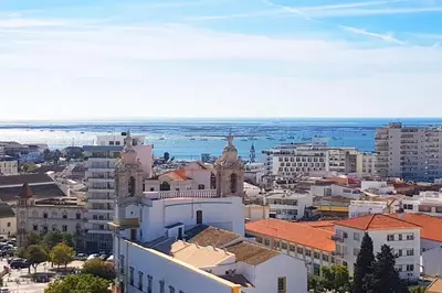 an aerial view of a city with buildings at Skyline Blue Dream in Faro