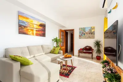 a living room with a white couch and a table at Skyline Blue Dream in Faro