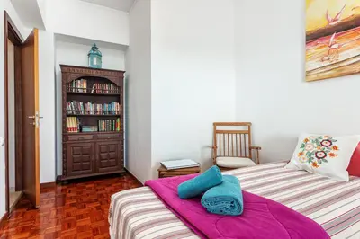 a bedroom with a bed and a book shelf at Skyline Blue Dream in Faro