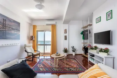 a living room with a couch and a tv at Sea View Fairy Tale in Faro