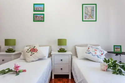 two white beds in a room with two lamps at Sea View Fairy Tale in Faro