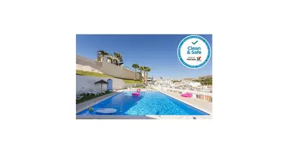 a villa with a swimming pool and a beach at Apartamento sobre a praia in Olhos de Água
