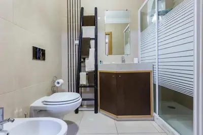 a bathroom with a toilet and a sink and a shower at Apartamento sobre a praia in Olhos de Água