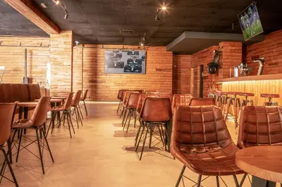 a restaurant with chairs and tables and a bar at 3HB Guarana - All Inclusive in Albufeira