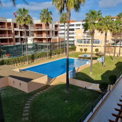 an overhead view of a swimming pool with palm trees at Vilamoura, Marina Sol T1 in Quarteira