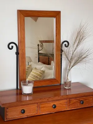 a wooden dresser with a mirror on top of it at Casa Alves - Villa with private heated swimming pool in Olhos de Água
