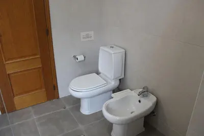 a bathroom with a toilet and a sink at Casa Alves - Villa with private heated swimming pool in Olhos de Água