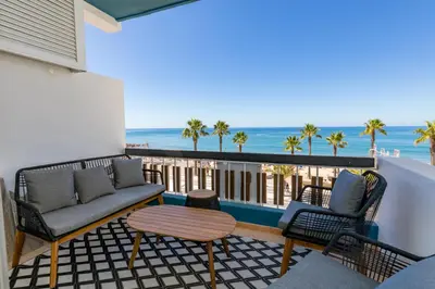 two white beds in a room with a window at Quarteira Beach Stunning Apartment in Quarteira