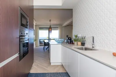 a dining room with a table and chairs at Quarteira Beach Stunning Apartment in Quarteira