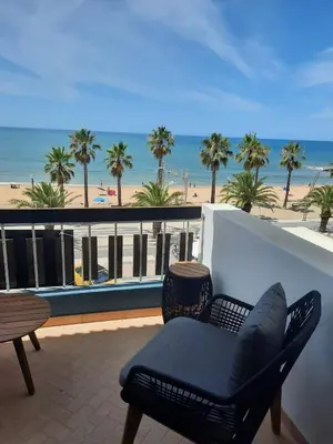 a dining room with a glass table and chairs at Quarteira Beach Stunning Apartment in Quarteira