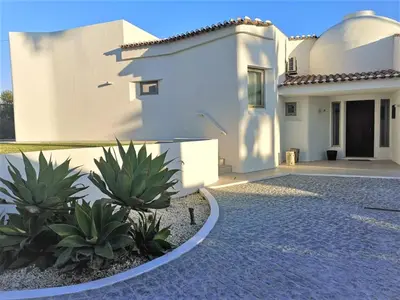 a white house with a courtyard and some plants at Villa Namora - Private Swimming pool & Hot Jacuzzi in Albufeira