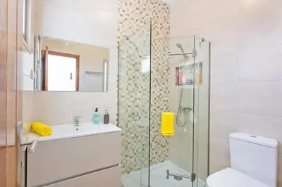 a bathroom with a shower and a toilet and a sink at Villa Namora - Private Swimming pool & Hot Jacuzzi in Albufeira