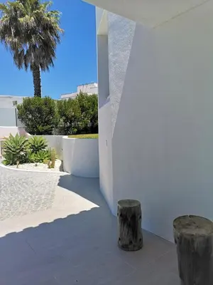 two wooden stools on a patio with a palm tree at Villa Namora - Private Swimming pool & Hot Jacuzzi in Albufeira