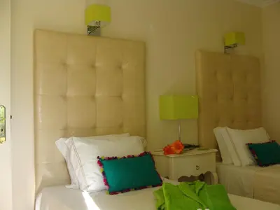 a bedroom with a bed with two pillows on it at Casa Coral in Albufeira