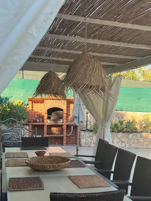 a patio with a table and a pizza oven at Casa Coral in Albufeira
