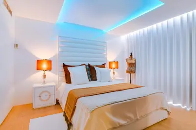 a bedroom with a large bed with two lamps on it at Gold Suites - Luxurious apartment - Sea view in Vilamoura