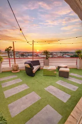 a table and chairs sitting under a pergola at Penthouse with Private Rooftop & Seaview in Guia