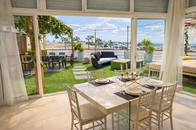 a canopy bed on a balcony with green grass at Penthouse with Private Rooftop & Seaview in Guia